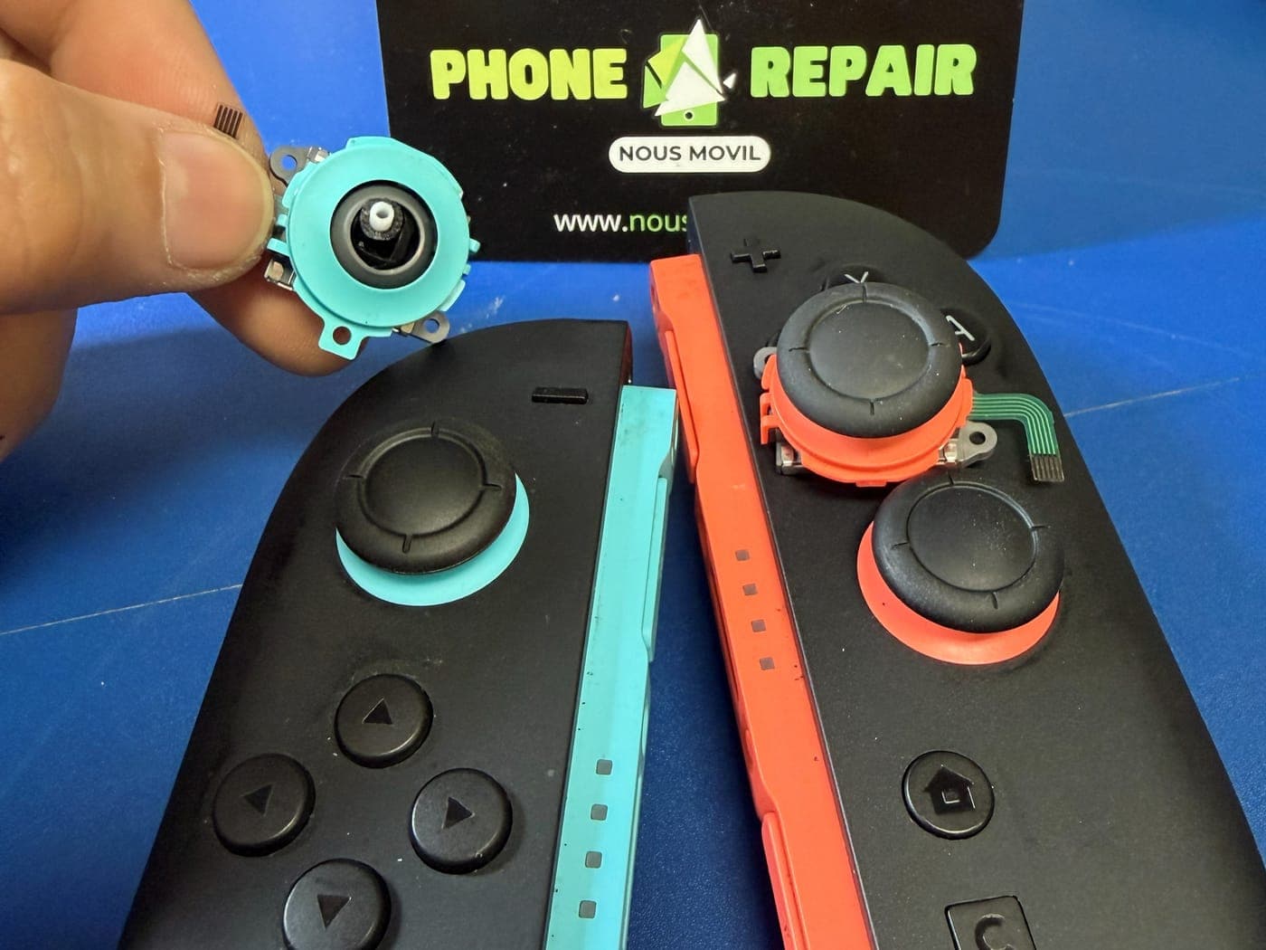 Joy-Con de Nintendo Switch durante el cambio del joystick, con el módulo desgastado en la mano del técnico